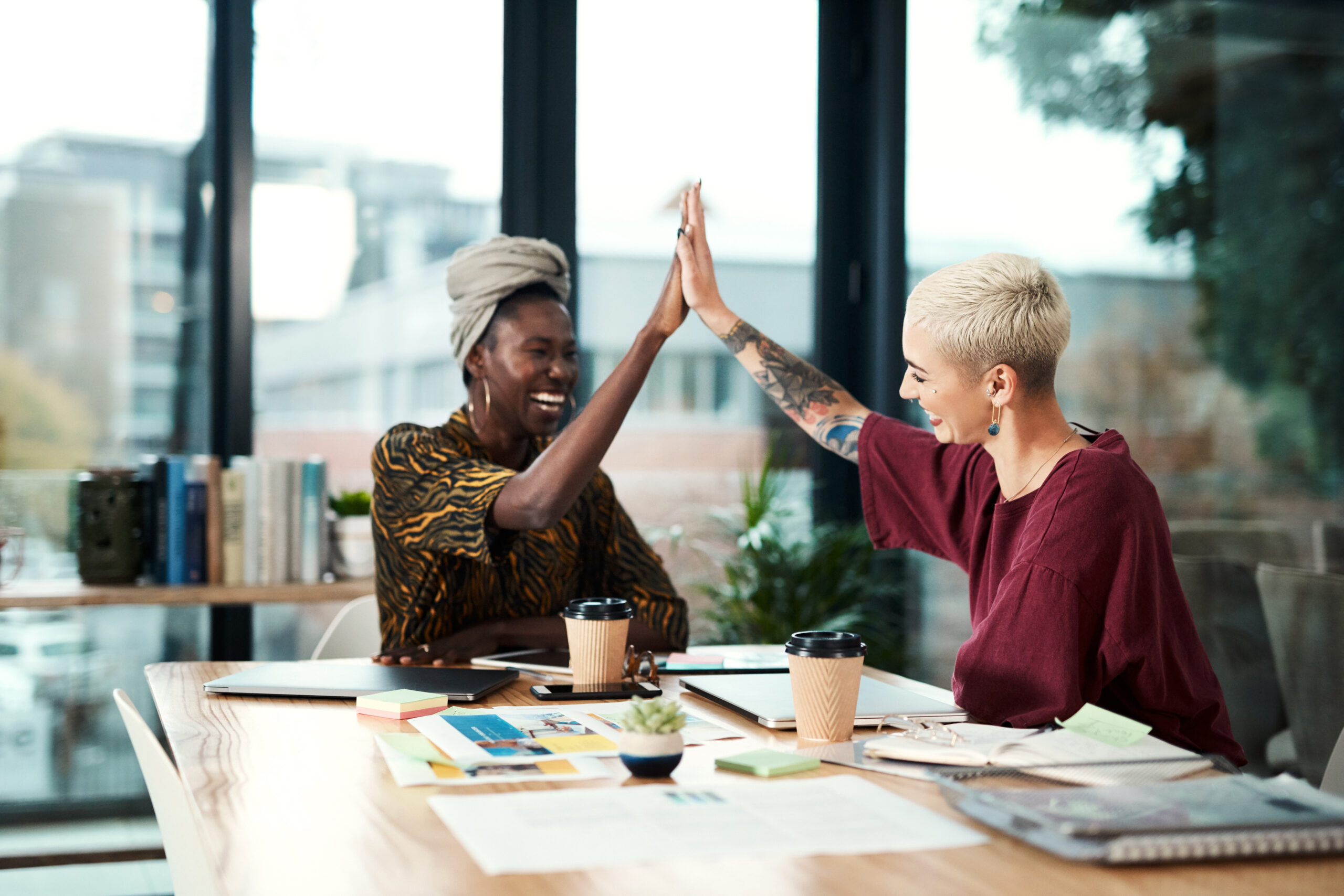 two women business owners high fiving