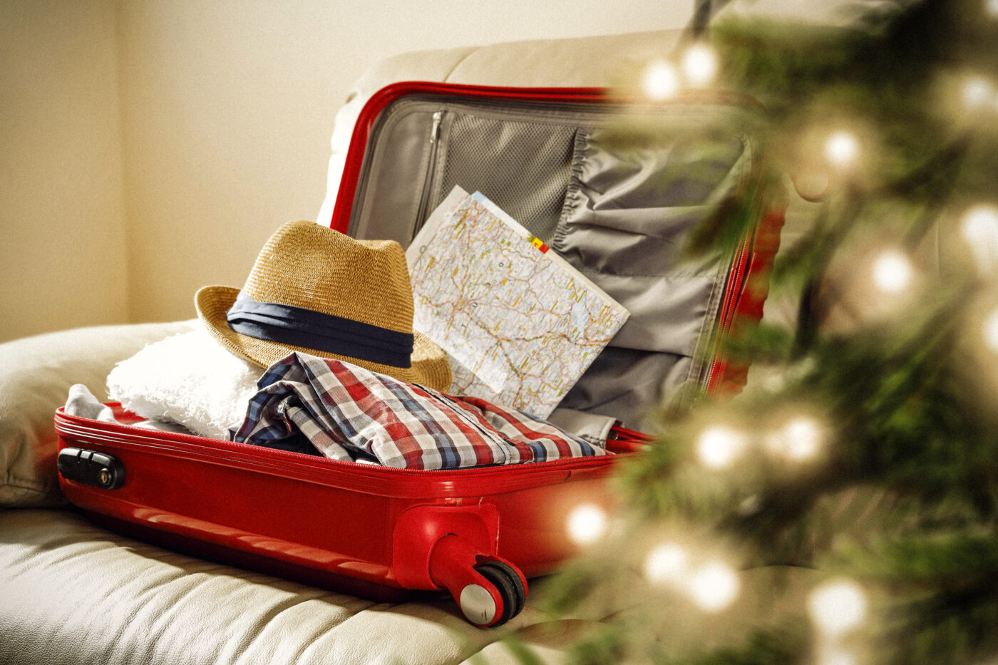 red suitcase and christmas tree decoration